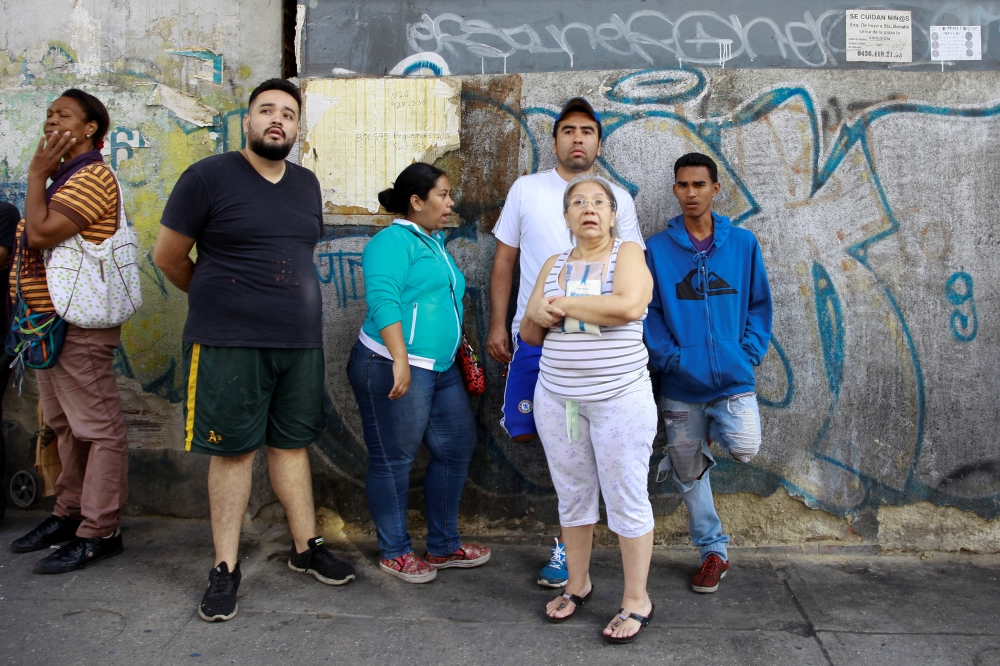 People look at the damage in a building after an explosion in Caracas, Venezuela August 5, 2018. Reuters/Adriana Loureiro