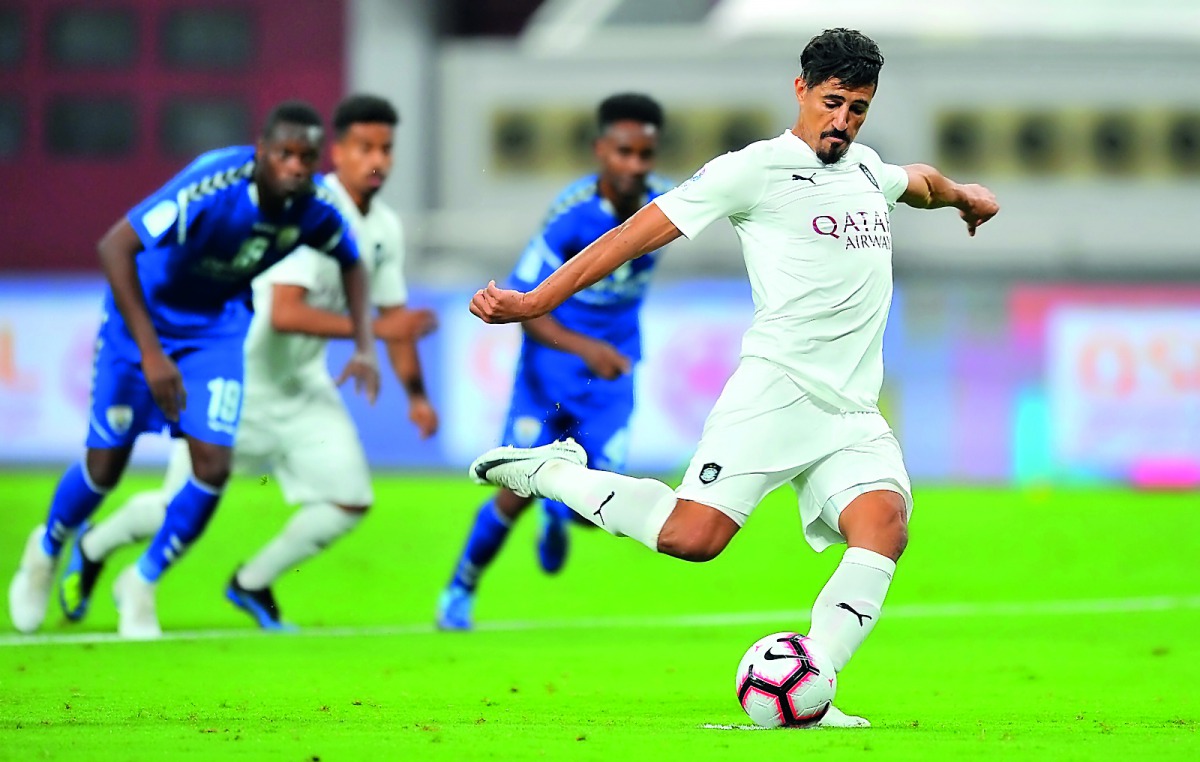 Al Sadd’s Algerian forward Baghdad Bounedjah shoots from penalty spot to score against Al Kharaitiyat during their QNB Stars League match played at the Khalifa International Stadium yesterday. Pictures by: Baher Amin / The Peninsula