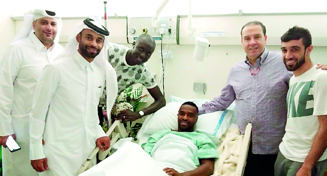Al Duhail officials pose for a photograph with injured forward Ismail Mohammed at Hamad Hospital in Doha yesterday.