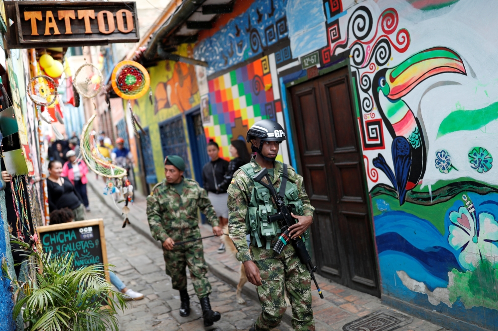 Members of the security forces walk near Bolivar square, where Colombia's President-elect Ivan Duque will be sworn in today, in Bogota, Colombia August 7, 2018. Reuters/Carlos Garcia Rawlins