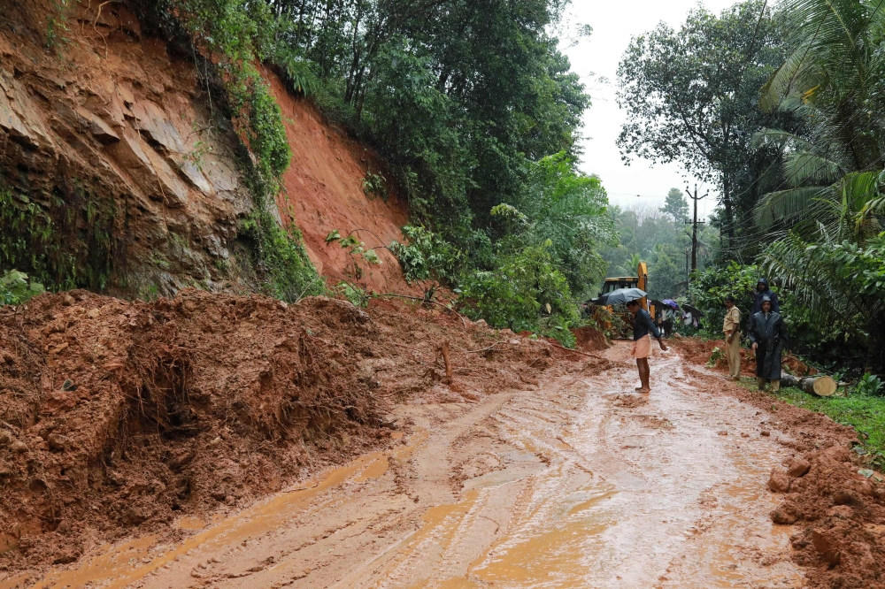 Indian rescuers conduct rescue operations after a landslide at Kuttampuzha village in Ernakulam district in the Indian state of Kerala on August 9, 2018.  AFP 
