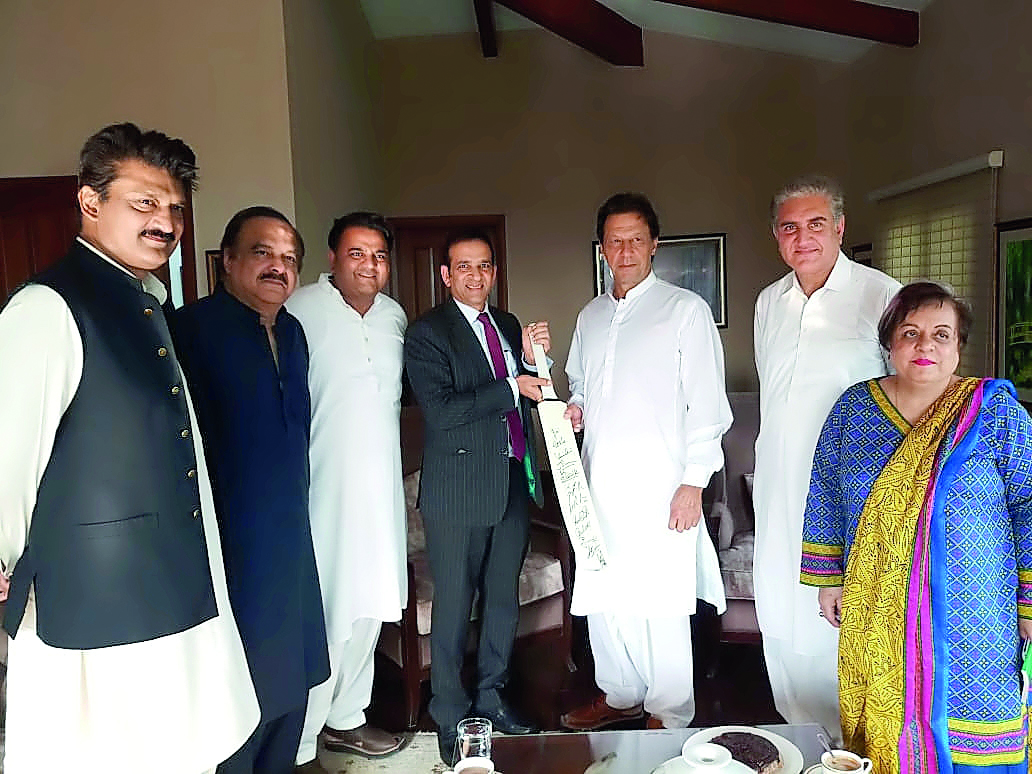 Indian High Commissioner Ajay Bisaria with Imran Khan in Islamabad yesterday. Bisaria gifted Khan a cricket bat autographed by the entire Indian cricket team. (Twitter)