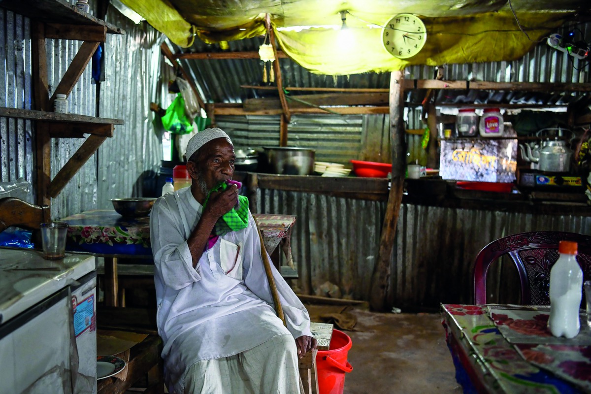 A Rohingya refugee man drinks tea at a local tea stall at the Kutupalong camp in Ukhia near Cox's Bazar on August 10, 2018. AFP / Chandan Khanna