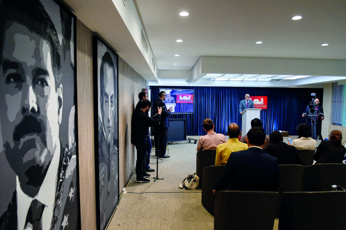 Venezuela's Communications Minister Jorge Rodriguez (C), offers a press conference on the detention of opposition lawmaker, Juan Requesens, accused of involvement in an apparent attack against President Nicolas Maduro, at the Miraflores presidential palac