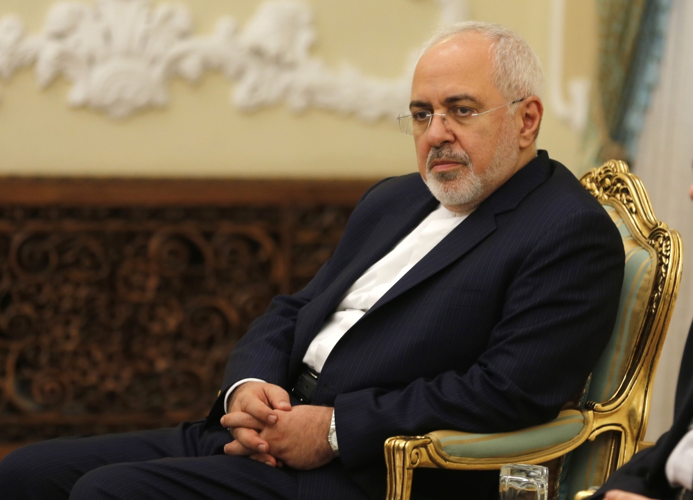 Iran's Foreign Minister Mohammad Javad Zarif listens during Iranian President Hassan Rouhani meeting with North Korea's Foreign Minister Ri Yong Ho in the capital Tehran on August 8, 2018. / AFP / ATTA KENARE 