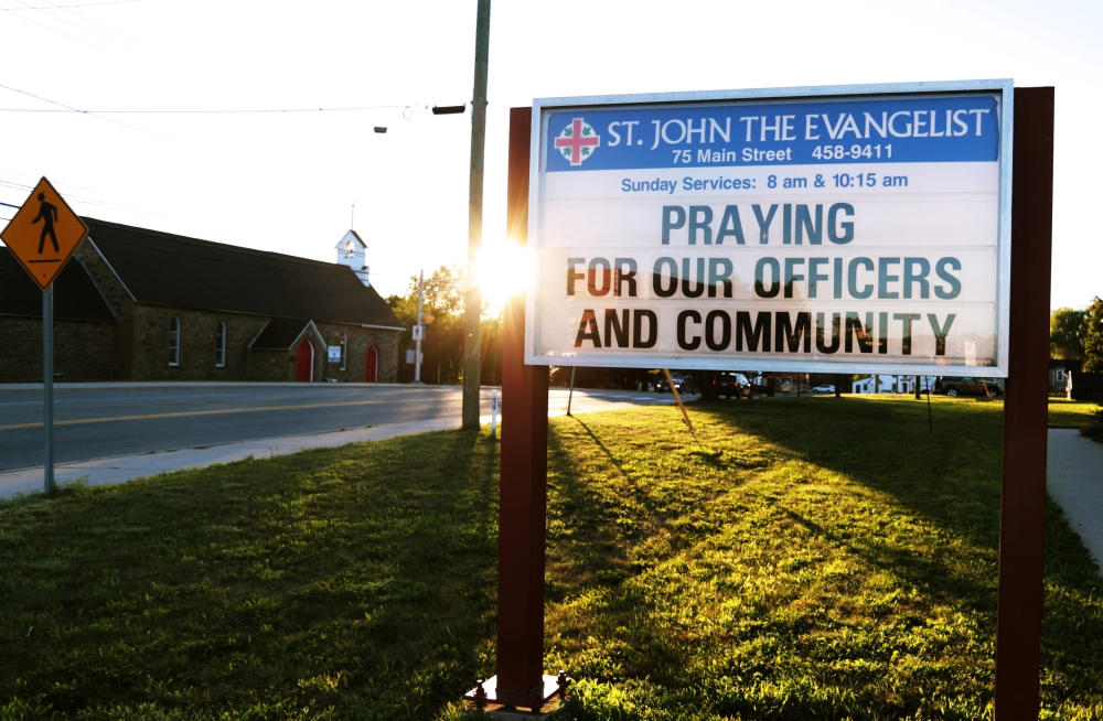 A message at the St. John the Evangelist Anglican Church notifies the community of a prayer vigil after a shooting incident in Fredericton, New Brunswick, Canada, August 10, 2018. Reuters/Dan Culberson 
 
 