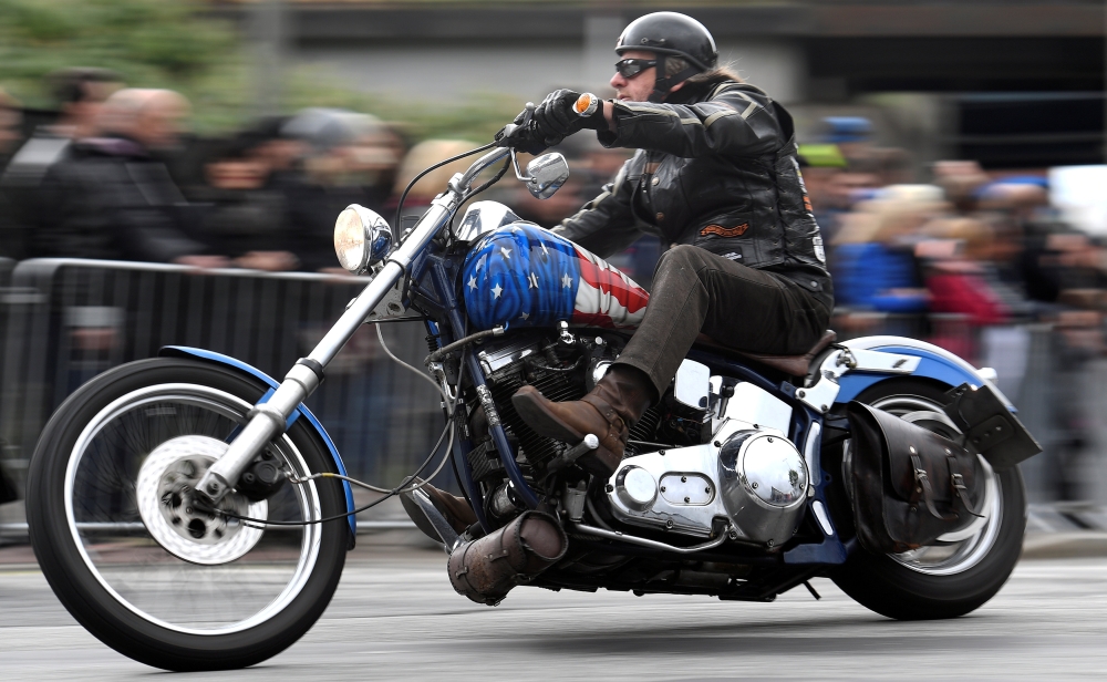A biker rides his Harley-Davidson during a parade at the 