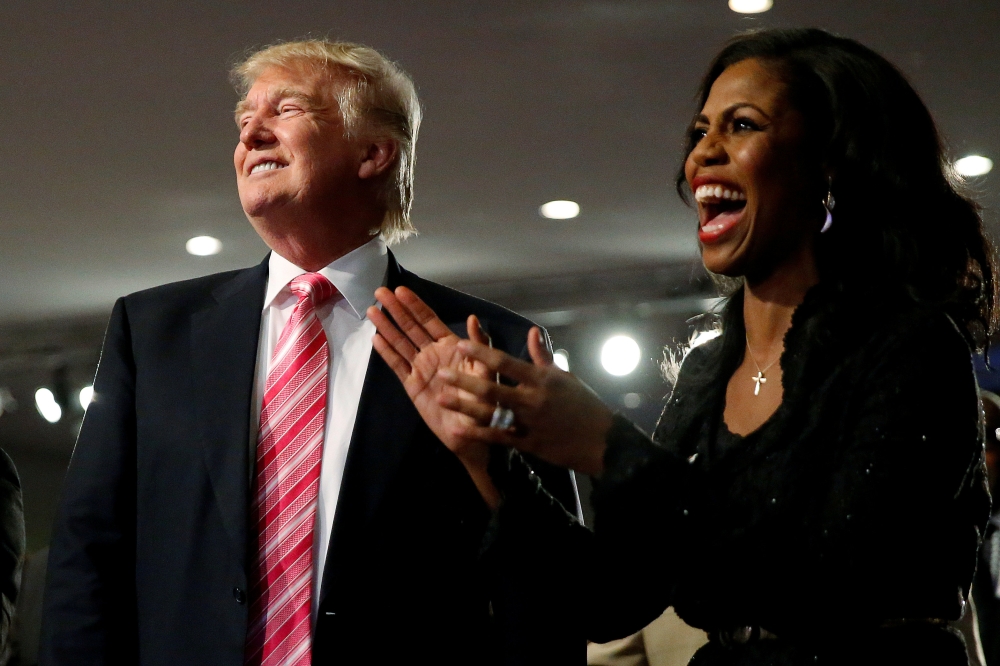Republican presidential nominee Donald Trump and Omarosa Manigault (R) attend a church service, in Detroit, Michigan, U.S., September 3 2016. Reuters/Carlo Allegri