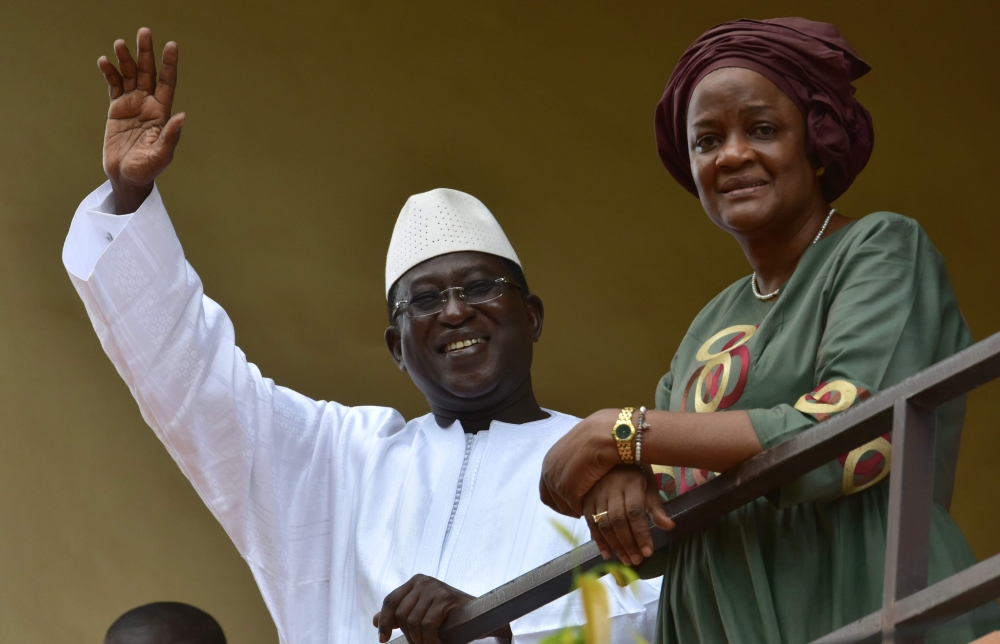 Malian Opposition leader and presidential candidate SoumaIila Cisse and his wife Astan Traore waves to supporters in the front of his residence on August 13, 2018 in Bamako a day after the runoff vote in Mali's presidential election.  AFP / Issouf Sanogo 