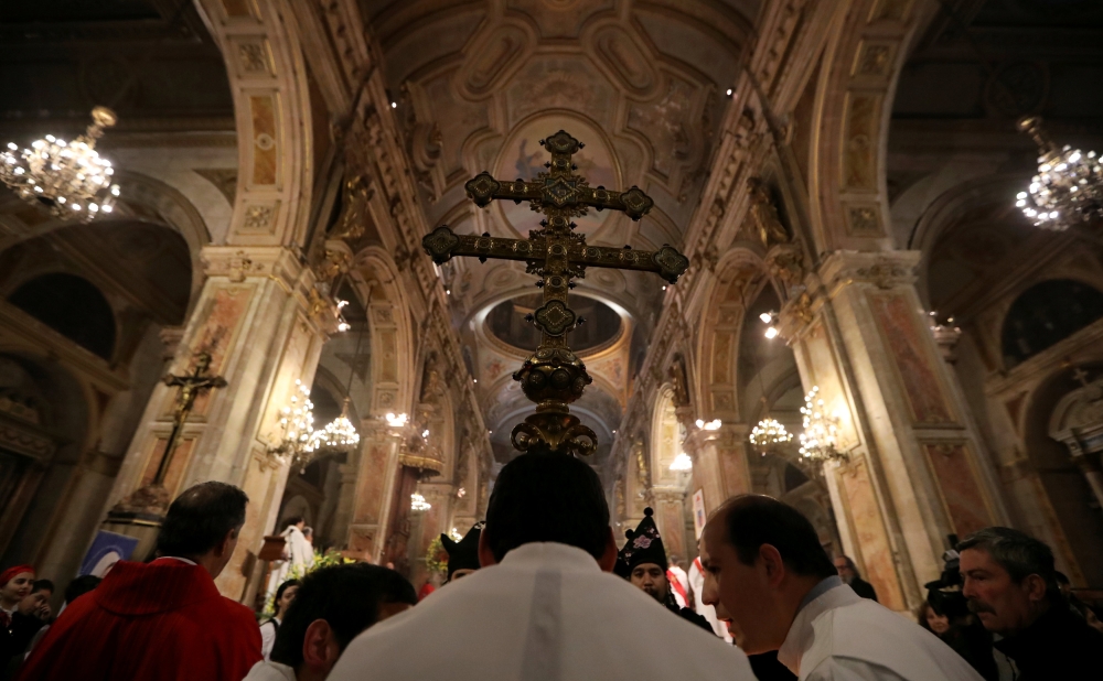 Members of the church hold a cross during a mass at the Santiago cathedral, in Santiago, Chile July 25, 2018. Reuters/Ivan Alvarado 