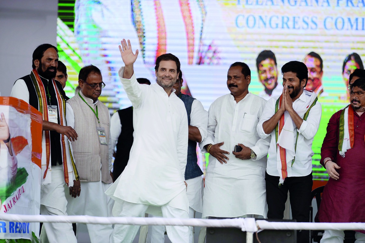 Congress party president Rahul Gandhi (C) waves to supporters as he arrives to address a public meeting at Saroornagar Stadium in Hyderabad on August 14, 2018. Gandhi is on a two-day visit to the capital city of Southern Indian State of Telangana. AFP / N