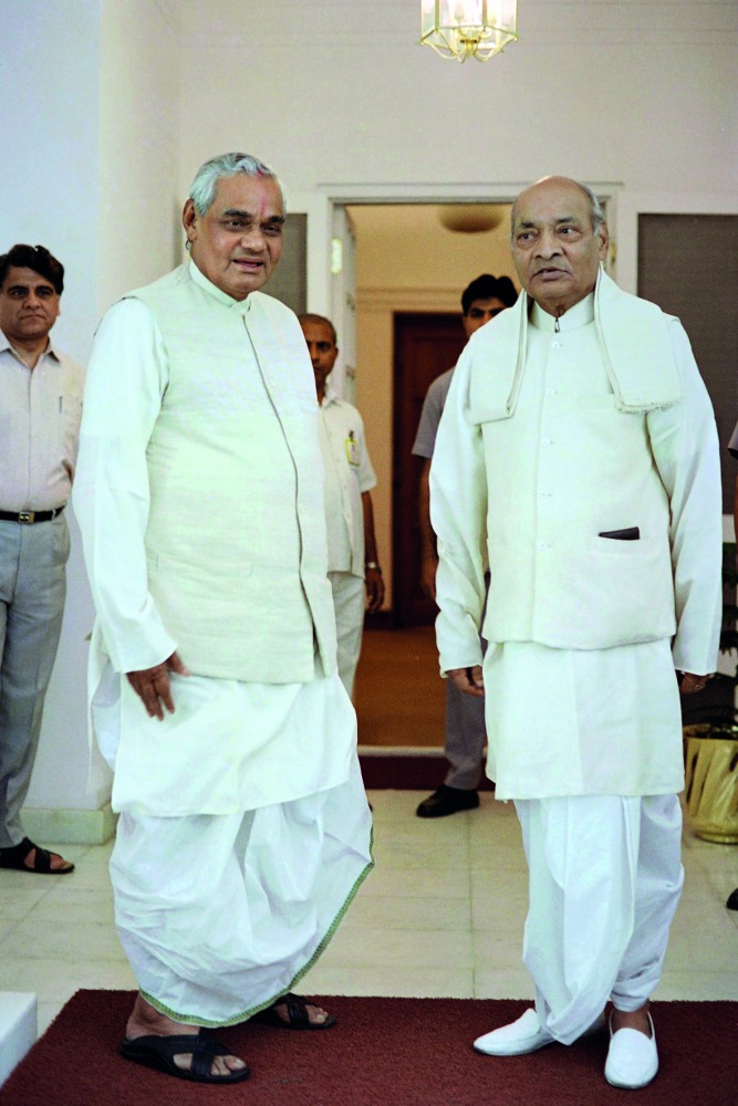 This file photo taken on May 17, 1996 shows Indian Prime Minister Atal Bihari Vajpayee (L), leader of the right wing Bharatiya Janata Party (BJP), taking part in a campaign, in New Delhi.  AFP / Teki Tanwar 