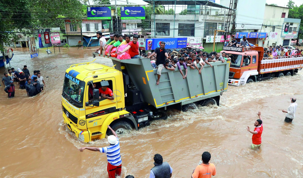 People travel in a truck to a safer place as flood waters ravaged the National Highway 47 in Ernakulam district of Kochi, in the Indian state of Kerala, on August 17, 2018.  AFP 