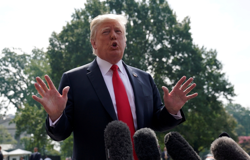 U.S. President Donald Trump speaks to reporters upon his departure from the White House in Washington, U.S., August 17, 2018. REUTERS/Kevin Lamarque/File Photo