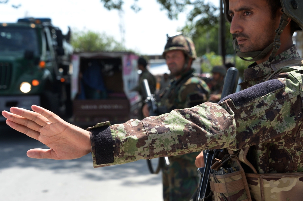 File photo shows Afghan National Army (ANA) soldiers search vehicles at a checkpoint. (AFP / NOORULLAH SHIRZADA / File photo)