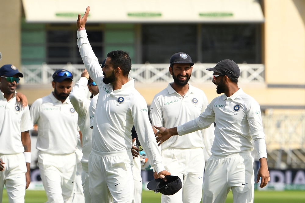 India's captain Virat Kohli (C) waves after winning the fourth day of the third Test cricket match between England and India at Trent Bridge in Nottingham, central England on August 21, 2018. (AFP / Paul ELLIS)