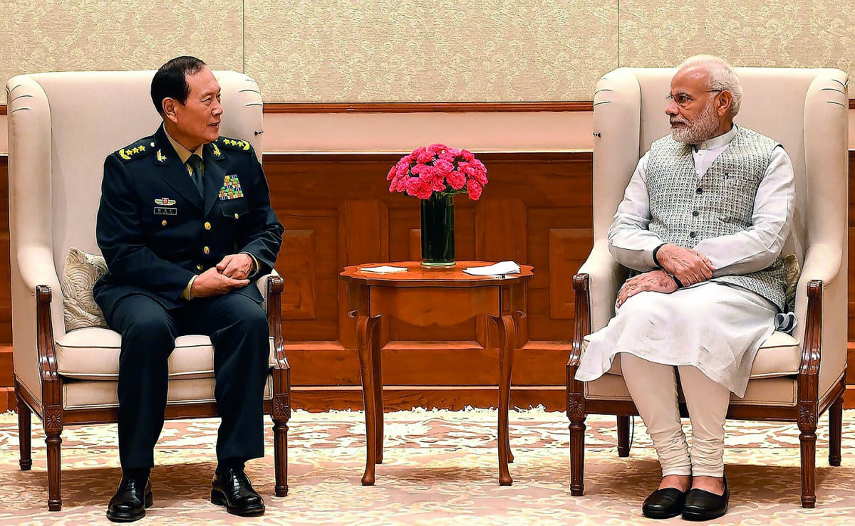 This handout photograph released by India's Press Information Bureau (PIB) on August 21, 2018 shows Indian Prime Minister Narendra Modi (R) meeting with China's Defense Minister Wei Fenghe in New Delhi. AFP / PIB