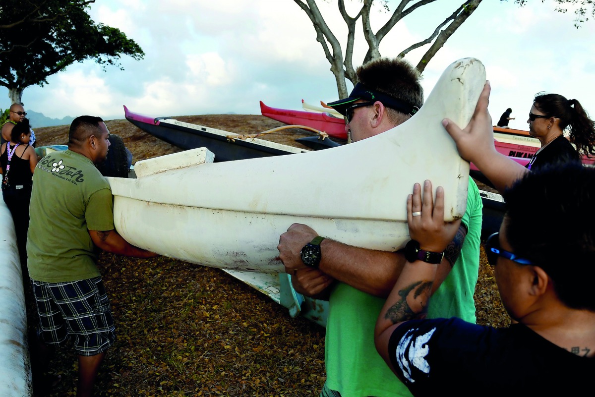 Members of the Alapahoe outrigger canoe club move their canoes off the beach to higher ground as Hurricane Lane approaches Honolulu, Hawaii, U.S. August 21, 2018. Picture taken August 21, 2018. Reuters/Hugh Gentry