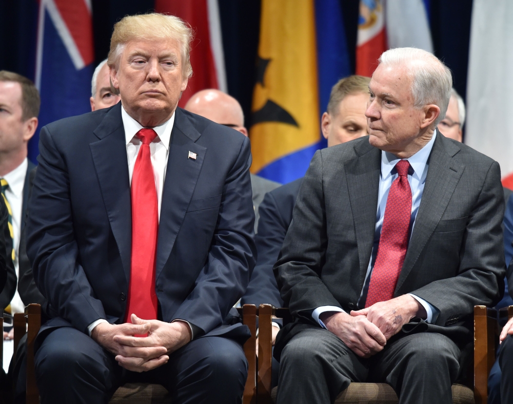 US President Donald Trump (L) sits with Attorney General Jeff Sessions in Quantico, Virginia, before participating in the FBI National Academy graduation ceremony on December 15, 2017.  AFP / Nicholas Kamm 
