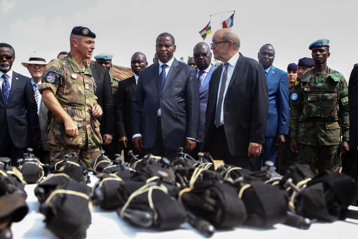 FILE PHOTO: French Defence Minister Jean-Yves Le Drian flanked by President of the Central African Republic Faustin-Archange Touadera looks at military supplies at the Mpoko military base in Bangui on October 31, 2016 AFP