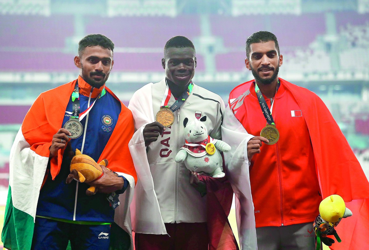 Gold medallist Abdalelah Haroun Hassan (centre) of Qatar, silver medallist Muhammed Anas Yahiya (left) of India and bronze medallist Ali Khamis of Bahrain pose with their medals after the 2018 Asian Games Men’s 400m final at the GBK Main Stadium in Jakart