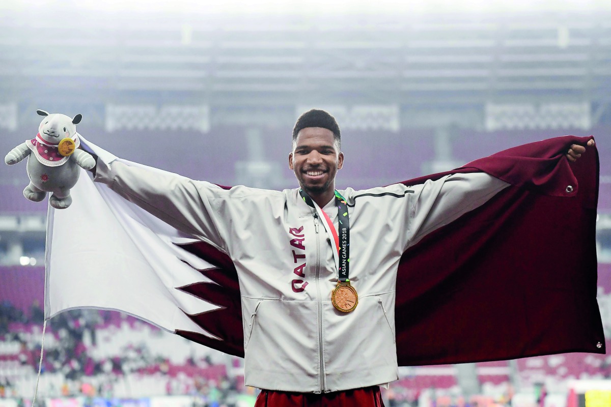 Gold medallist Qatar’s Abderrahman Samba celebrates during the victory ceremony for the men’s 400M hurdles event during the 2018 Asian Games in Jakarta yesterday. Samba (22), broke the Games record in the men’s 400m hurdles when he finished his run in 47.