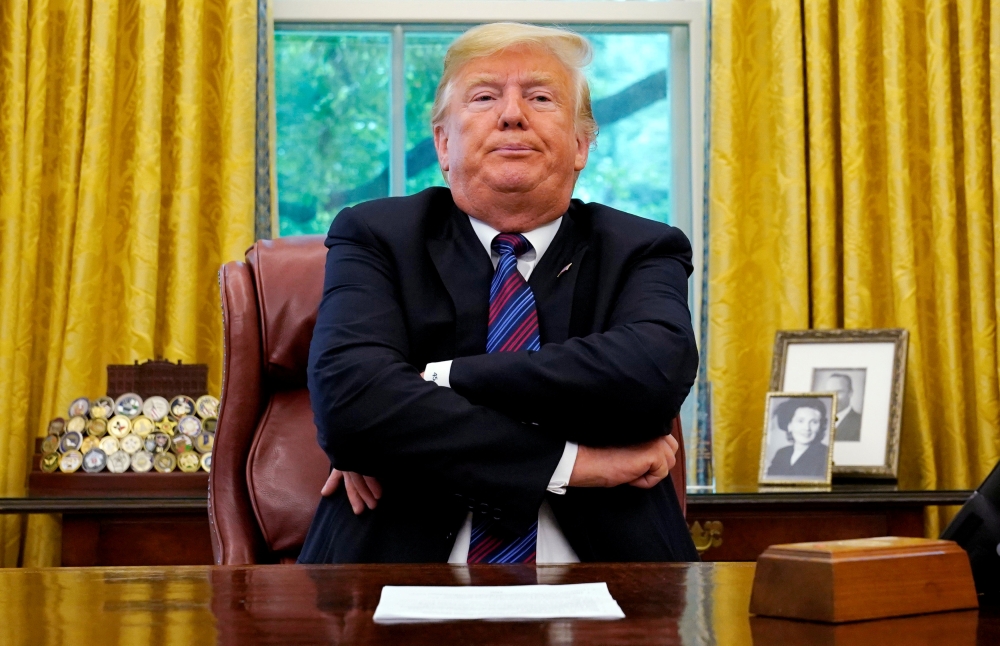 US President Donald Trump sits behind his desk as he announces a bilateral trade agreement with Mexico to replace the North American Free Trade Agreement (NAFTA) at the White House in Washington, US, August 27, 2018. REUTERS/Kevin Lamarque