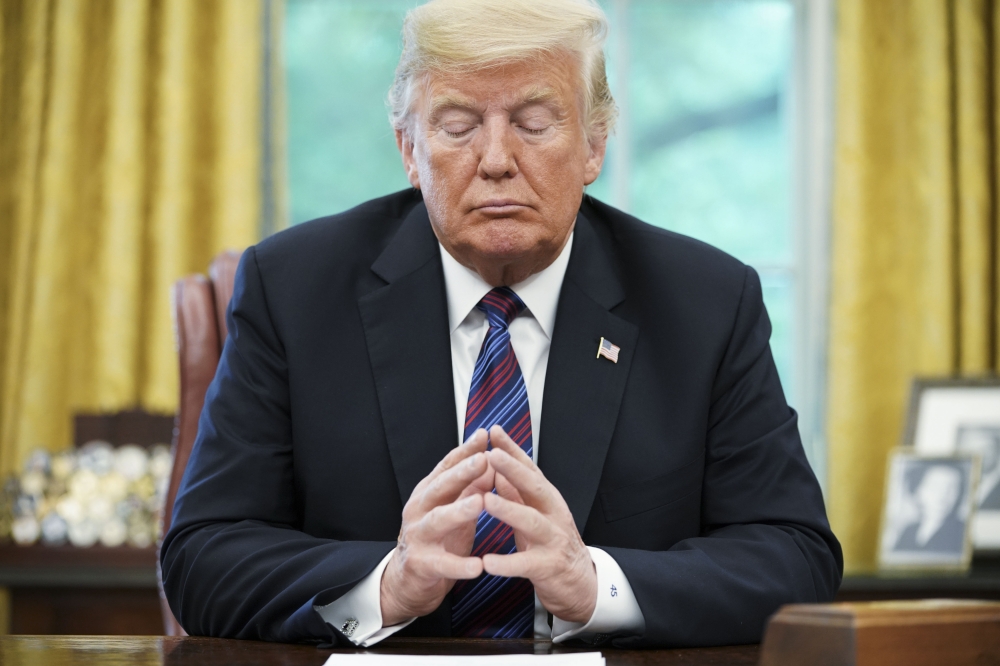 US President Donald Trump listens during a phone conversation with Mexico's President Enrique Pena Nieto on trade in the Oval Office of the White House in Washington on August 27, 2018.