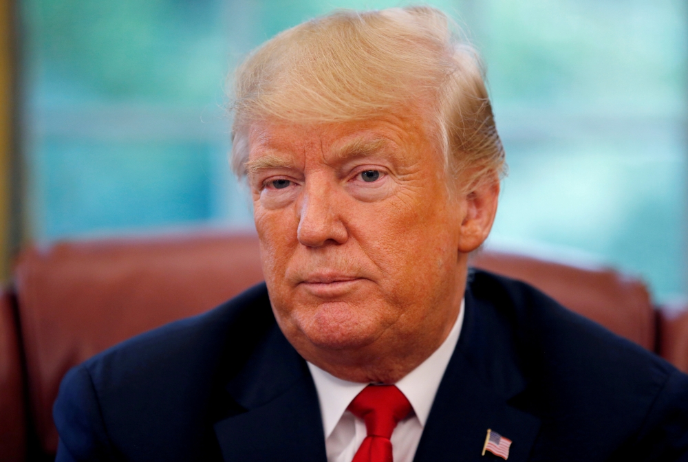 FILE PHOTO: U.S. President Donald Trump listens to a question during an interview with Reuters in the Oval Office of the White House in Washington, U.S. August 20, 2018. REUTERS/Leah Millis