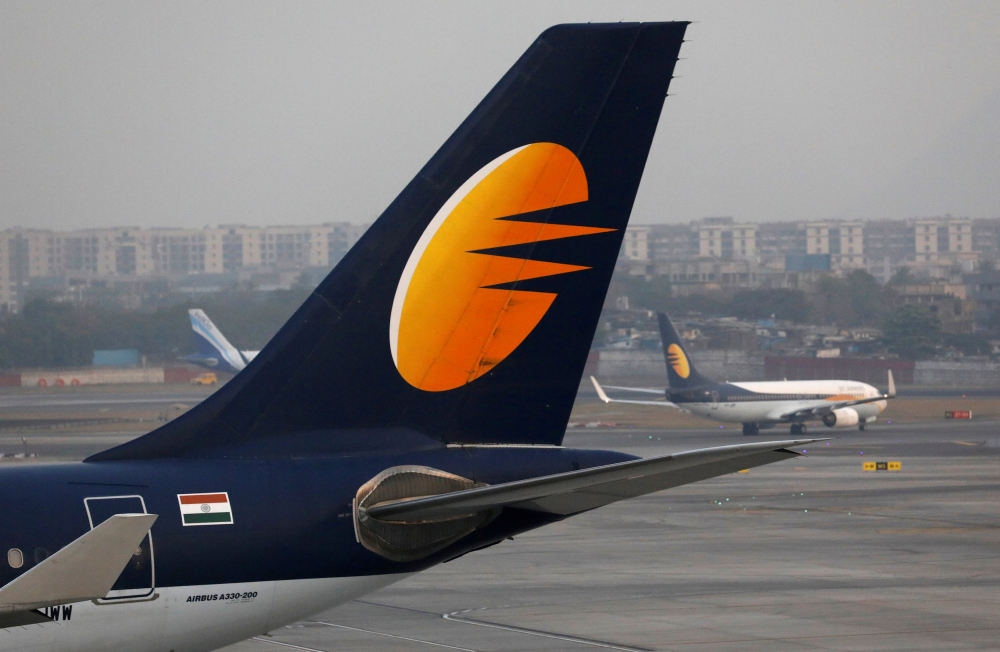 :FILE PHOTO: A Jet Airways plane is parked as other moves to runway at the Chhatrapati Shivaji International airport in Mumbai, India, February 14, 2018. REUTERS/Danish Siddiqui