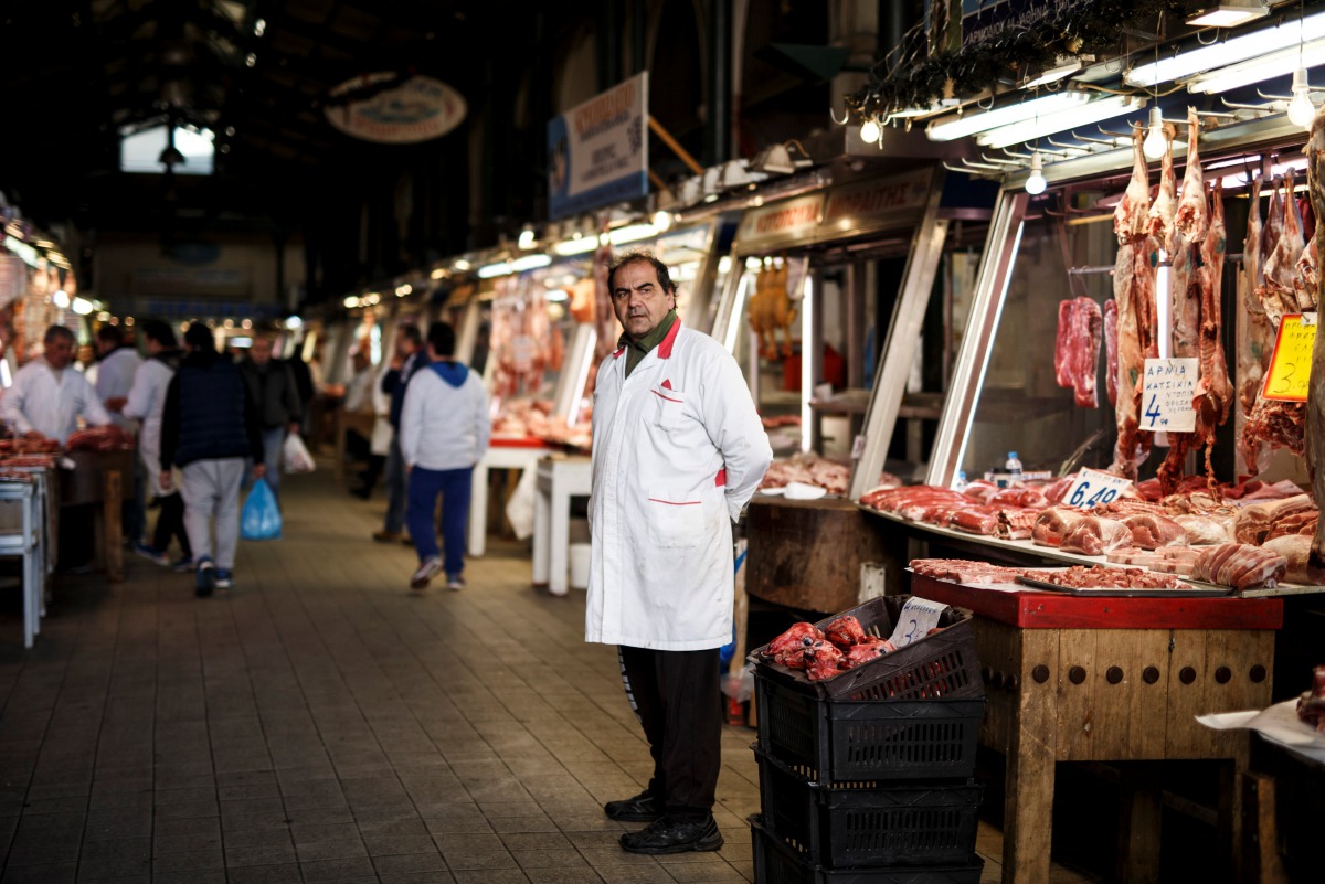 A butcher waits for clients inside the main meat market of Athens, Greece, February 17, 2017. (Reuters/Alkis Konstantinidis) 