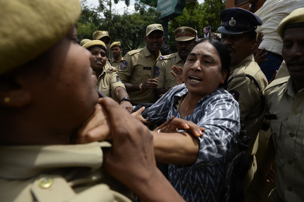 A Progressive Organisation for Women (POW) activist scuffles with police during a protest against the arrest of Indian poet and activist Varavara Rao in Hyderabad, on August 29, 2018. AFP / Noah Seelam
 