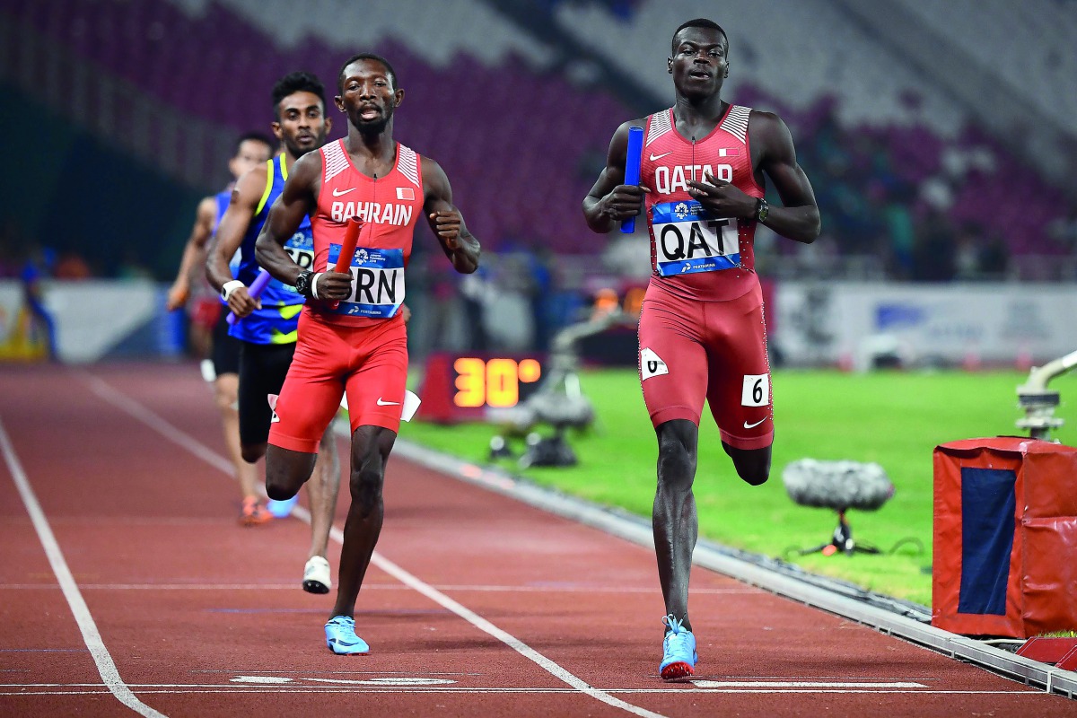 Qatar’s Abdalelah Hassan Haroun (right) wins the  second heat of the men’s 4x400m relay event during the 2018 Asian Games in Jakarta, Indonesia, yesterday.