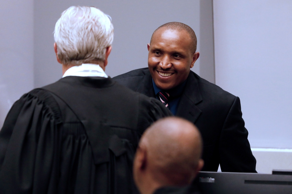 Former Congolese warlord Bosco Ntaganda (R) arrives at the courtroom of the International Criminal Court (ICC) during the closing statements of his trial in the Hague, the Netherlands, on August 28, 2018.  AFP / Bas Czerwinski
