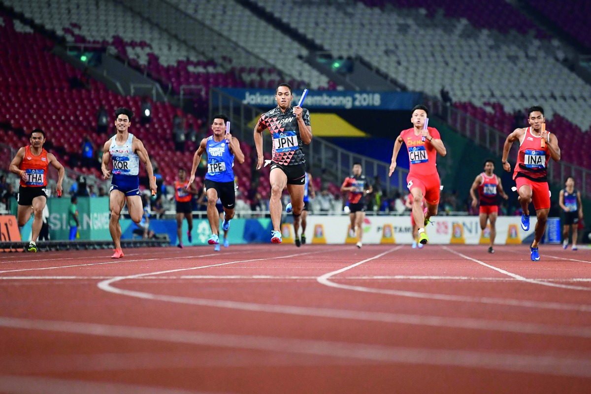 Japan’s Aska Cambridge (C) competes in the final of the men's 4x100m relay athletics event during the 2018 Asian Games in Jakarta on August 30, 2018. AFP / Jewel Samad 