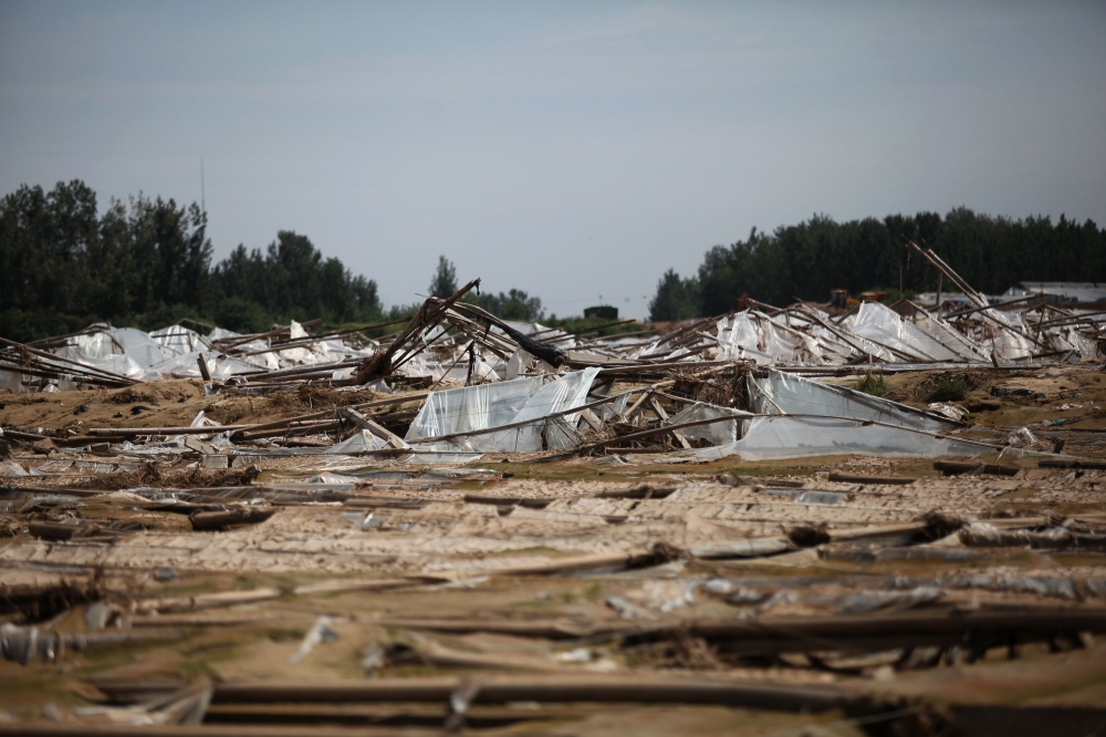 Vegetable greenhouses that were damaged after a flood caused by typhoon Rumbia hit the area are pictured in Shouguang in China's eastern Shandong province on August 31, 2018. typhoon Rumbia left at least 24 dead and 3 missing in Shandong, according to loc