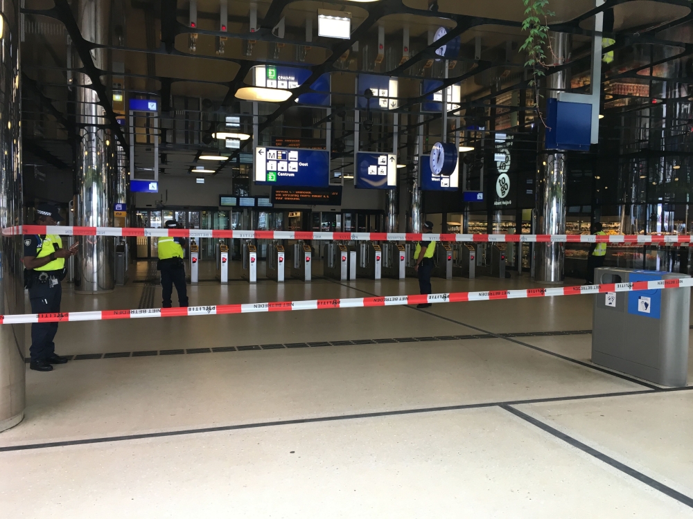 Security officials stand alert at The Central Railway Station in Amsterdam on August 31, 2018, after two people were hurt in a stabbing incident. / AFP / Germain Moyon