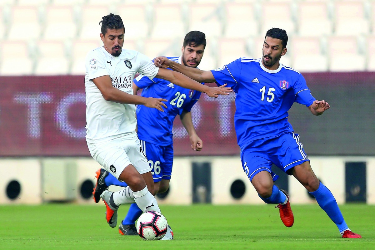 Al Sadd’s Baghdad Bounedjah vies for ball possession with Al Shahania during the QNB Stars League (QSL) match in Doha yesterday.