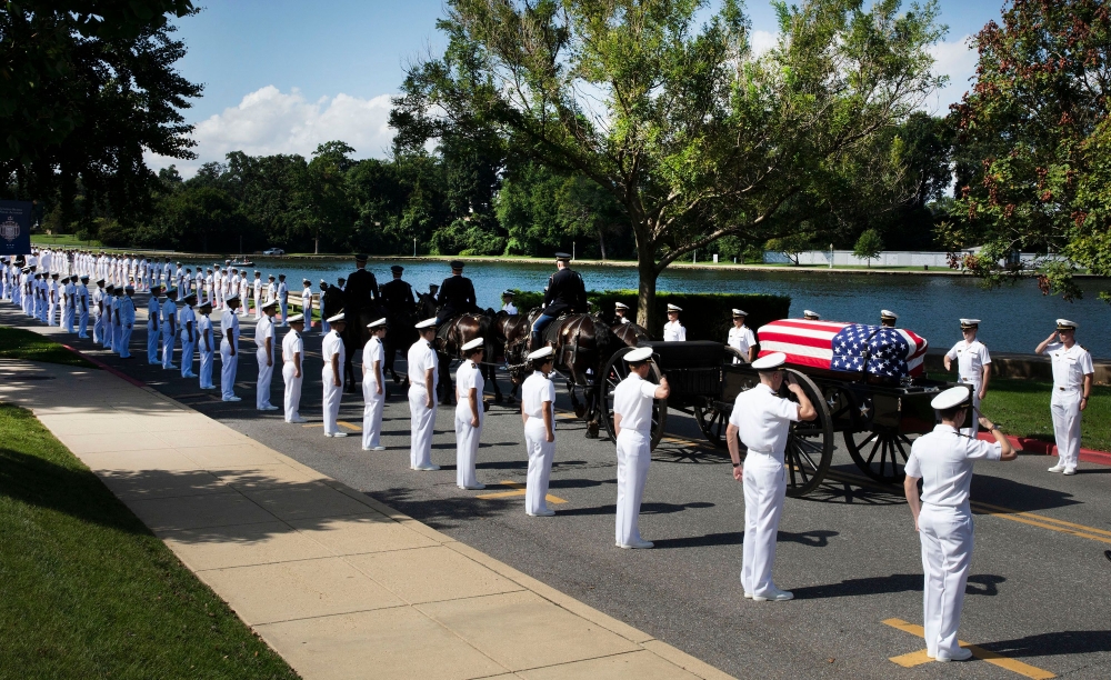 In this photo released by the McCain Family, the horse-drawn caisson bearing the body of Senator John McCain (R-AZ) moves through the grounds of the United Sates Naval Academy toward the cemetery after a service in the Chapel on September 2, 2018, in Anna