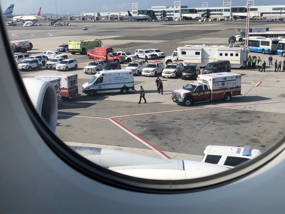 The emergency services are seen, after the passengers were taken ill on a flight from New York to Dubai, on JFK Airport, New York, U.S., September 05, 2018. Larry Coben/ REUTERS 
