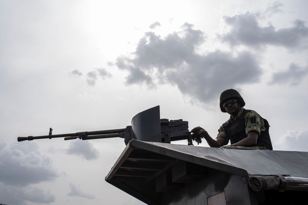 FILE PHOTO:  In this file photo taken on April 17, 2018 a member of the Nigerian Military Police sits on an armoured vehicle during the African Land Forces Summit (ALFS) military demonstration held at General Ao Azazi barracks in Gwagwalada. AFP / STEFAN 