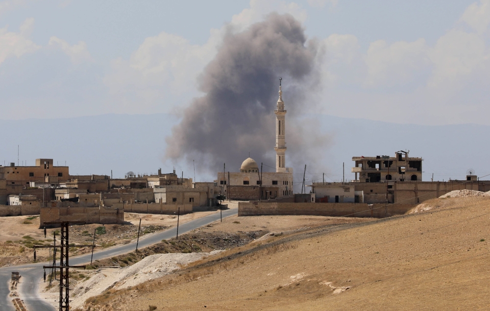 Smoke billows following Syrian government forces' bombardment around the town of Khan Sheikhun on the southern edges of the rebel-held Idlib province on September 8, 2018. AFP / OMAR HAJ KADOUR