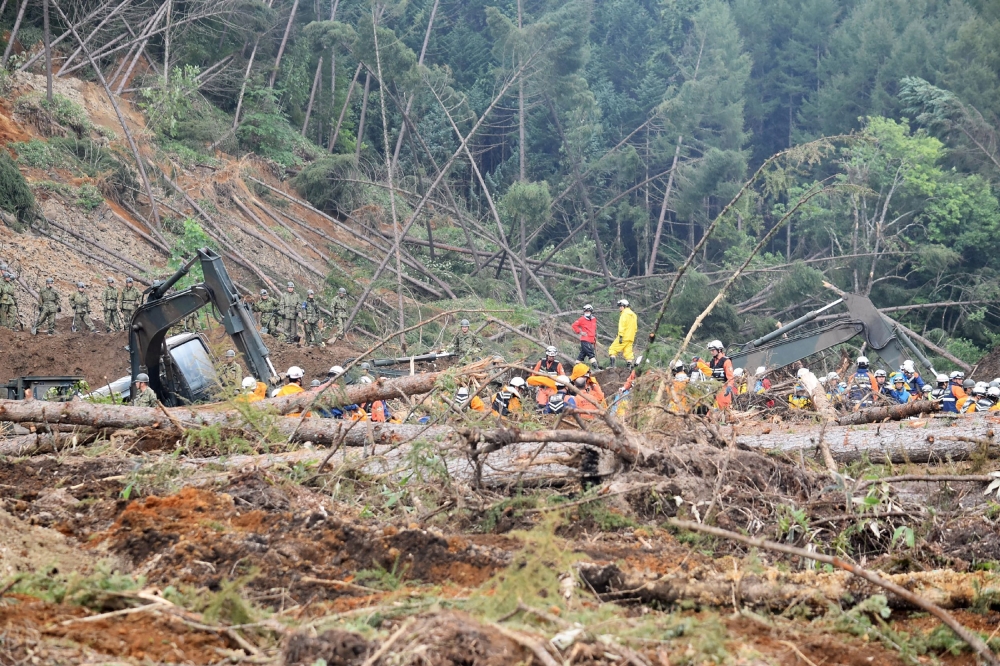 Self defence forces search for missing people in the devastated city of Atsuma on September 9, 2018 after a 6.6-magnitude earthquake hit the northern Japanese island of Hokkaido on September 6. Japan OUT / AFP / JIJI PRESS / Jiji Press