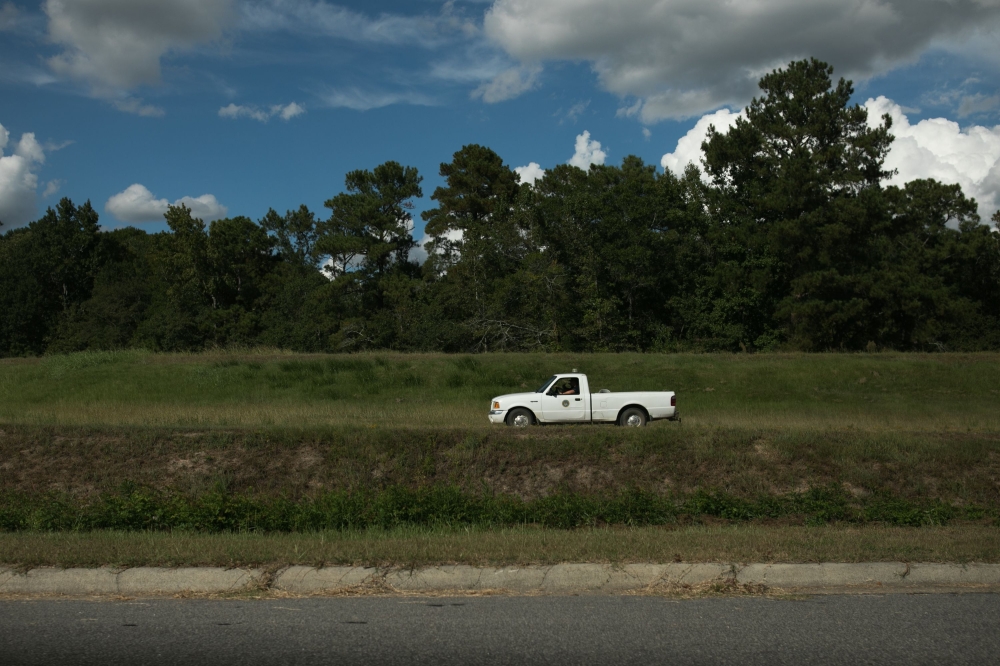 A county worker drives astride the levy along Lowery Street September 10, 2018 in Lumberton, North Carolina, ahead of Hurricane Florence. AFP / Logan Cyrus