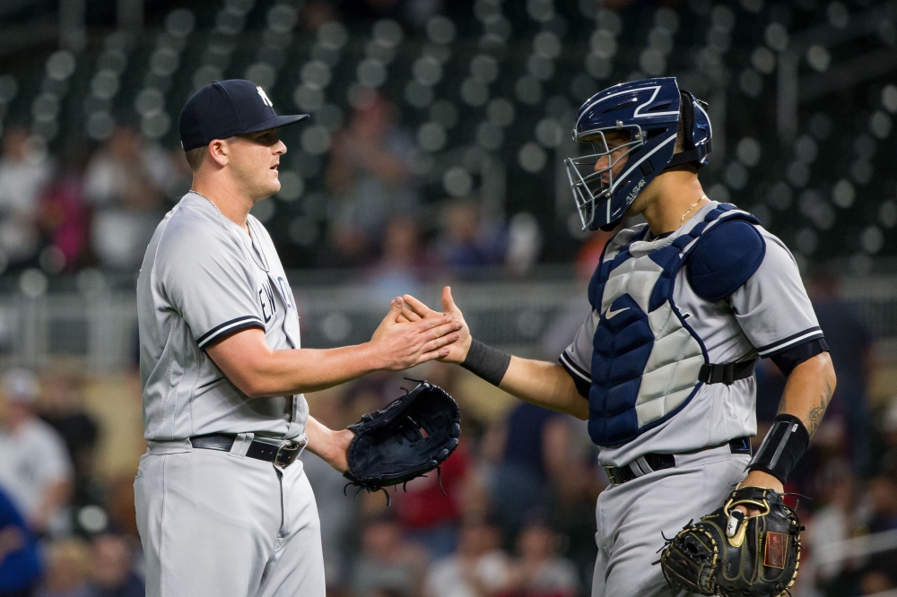 New York Yankees relief pitcher Jonathan Holder (56) and catcher Gary Sanchez (24) celebrate after the game against Minnesota Twins at Target Field. Brad Rempel-USA TODAY Sports