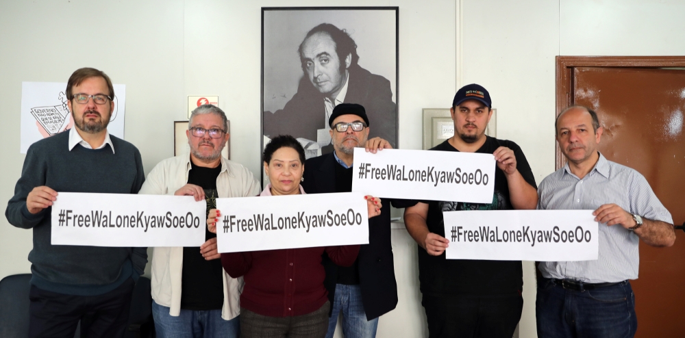 Members of the Union of Journalists of the state of Sao Paulo pose together in the union's headquarter to show solidarity for Reuters journalists Wa Lone, 32, and Kyaw Soe Oo, 28, who are imprisoned in Myanmar, in Sao Paulo, Brazil September 10, 2018. REU