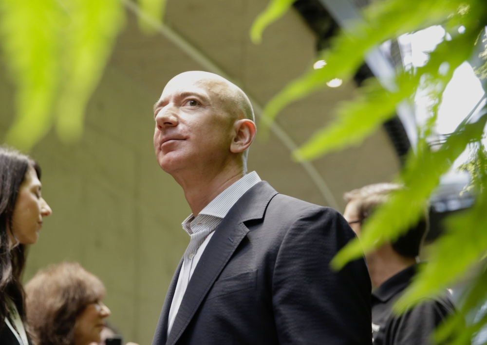 Amazon Chief Executive Officer Jeff Bezos tours the facility at the grand opening of the Amazon Spheres, in Seattle, Washington In this file photo taken on January 29, 2018. AFP / Jason Redmond 
