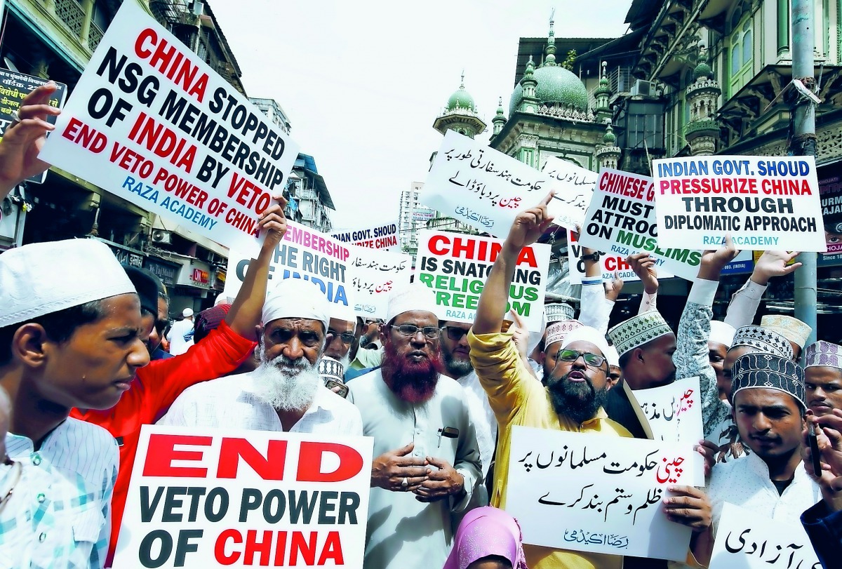 Protestors hold placards as they shout slogans during a protest against what they say is the Chinese government for detaining thousands of Uighur minority Muslims, at a street in Mumbai, India, September 14, 2018. Reuters/Francis Mascarenhas
