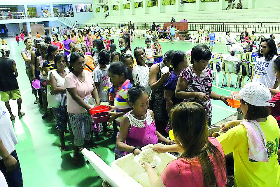 People are seen inside an evacuation centre in preparation for typhoon Mangkhut in Cagayan, Philippines, in this September 13, 2018 photo by LGU Gonzaga Cagayan from social media. via Reuters