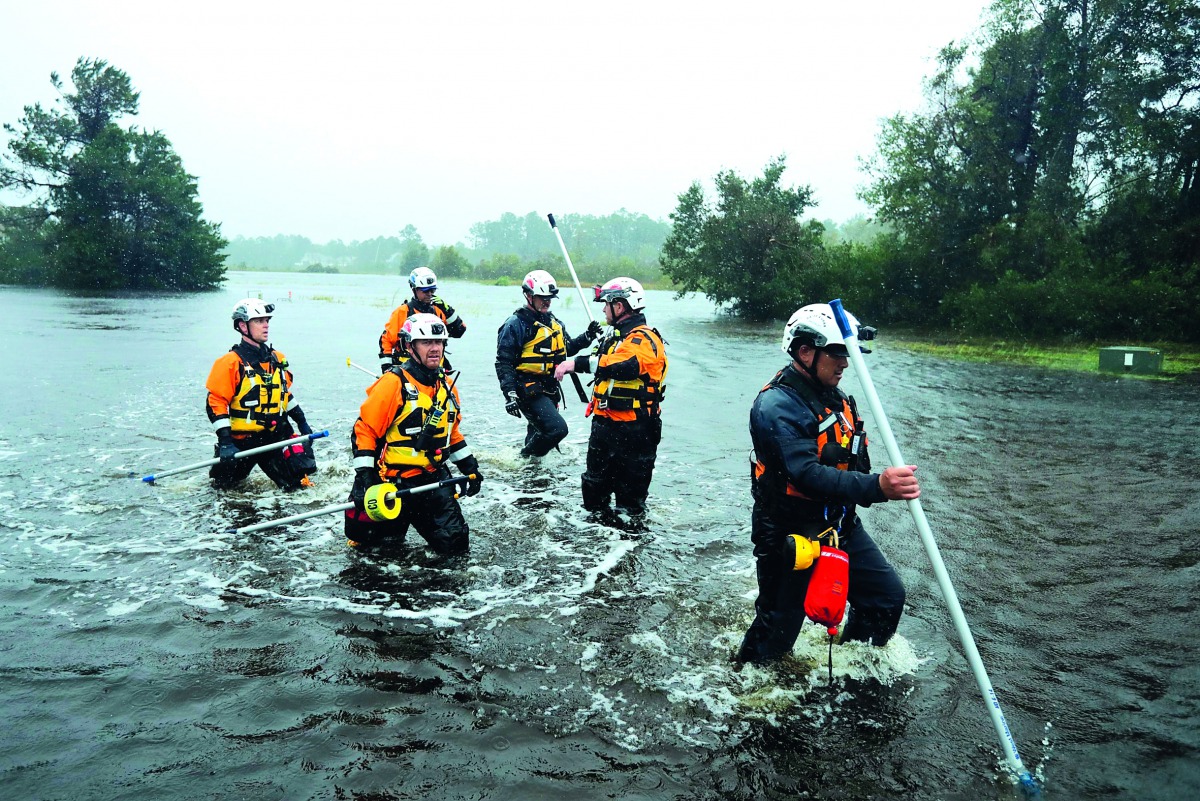 Members of the FEMA Urban Search and Rescue Task Force 4 from Oakland, California, search a flooded neighborhood for evacuees during Hurricane Florence September 14, 2018 in Fairfield Harbour, North Carolina. Chip Somodevilla/Getty Images/AFP 
